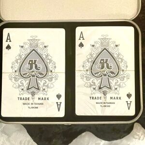 A double deck set of playing cards in a tin case. The cards are made in Taiwan